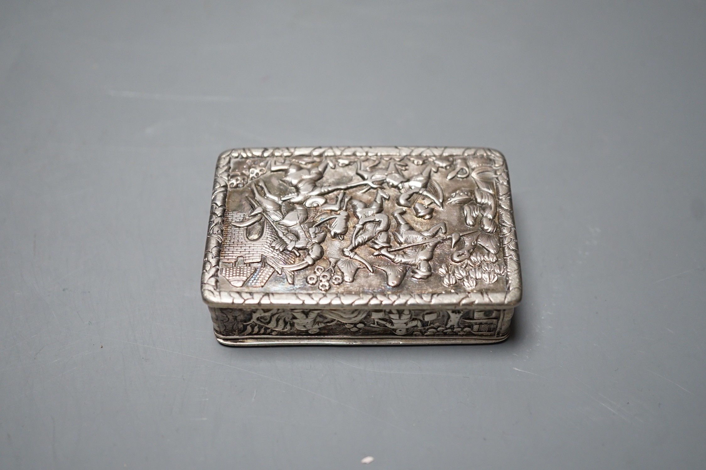 A Chinese export white metal snuff box, maker YS, 66mm, embossed with figures at various pursuits.